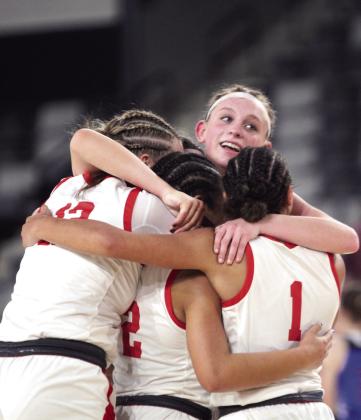 Four McLoud Lady Redskins celebrate with a group hug after winning the Class 4A State Quarterfinals.