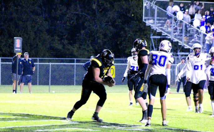 Tecumseh sophomore Dom Frizzell takes the ball to a referree after making a touchdown in the fourth quarter of the Oct. 12 home game with Bethany. The Savages lost, 14-49. Countywide &amp; Sun/Natasha Dunagan