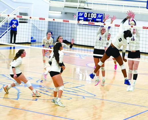 Tecumseh sophomore JaNya Bruner attacks and blocks the ball in the OSSAA Class 4A Volleyball State Quarter als. Photo courtesy of Kenetta Lisenbee.