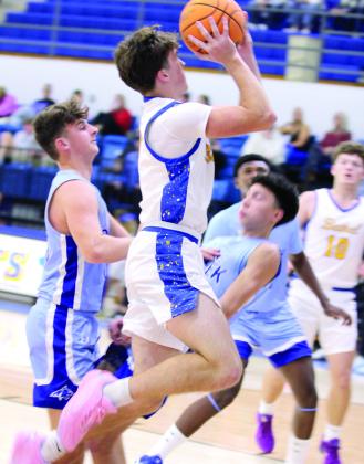 Bethel senior Zack Jennings soars past the Bridge Creek defense before launching the ball during the Dec. 5 home game. The Wildcats Natasha Dunagan, Countywide &amp;amp; Sun