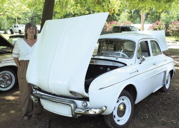 Carol Landers of Shawnee stands beside her 1964 Renault Dauphine during the 39th Annual Knights Auto Club Car Show at Boy Scout Park on June 27. Landers said she has had the rare French car for about two years.