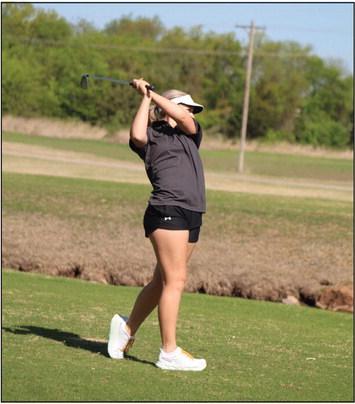 Tecumseh senior Sadie Boatman drives across a pond to the fifth hole of FireLake Golf Course during the Tecumseh Girls Golf Invitational on April 18. Boatman scored 107 at the tournament.