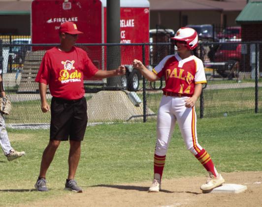 Dale junior Karsen Griggs gets a fist bump from Coach Andy Powell after hitting a triple in the fourth inning of the Dale Fastpitch Festival game with El Reno on Sept. 16.