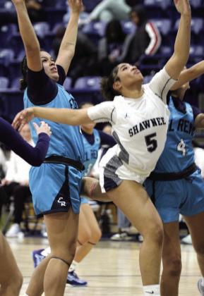 Shawnee sophomore Chrishelle Milum tries to put up a shot between two El Reno defenders and gets a foul at the Shawnee Invitational game on Jan. 25. The Lady Wolves beat Crooked Oak on Jan. 23, 62-19; lost to Coweta on Jan. 24, 4955; and fell to El Reno, 34-45. Countywide &amp; Sun/Natasha Dunagan
