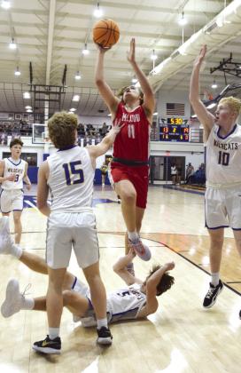 Castin Schafer reaches for the basket over Zack Jennings while Gavin Lynch tries to push him away in the Feb. 6th game at Bethel.