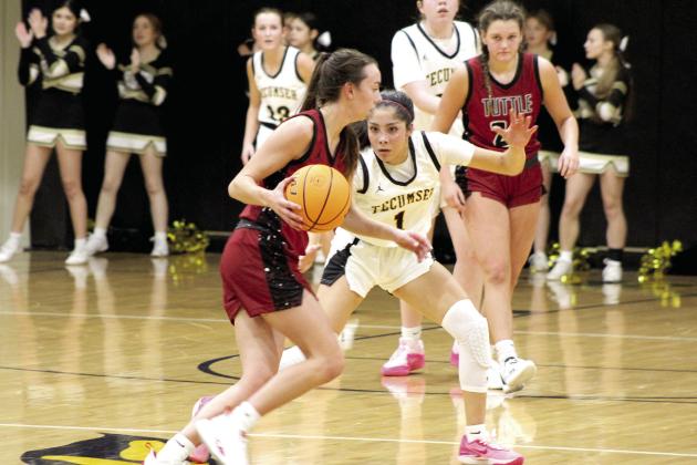 Tecumseh senior Serenity Jacoway keeps her eyes on the ball while on defense during the first home game against Tuttle, Nov. 28. The Lady Savages lost, 26-46. The Savages also lost, 62-72.