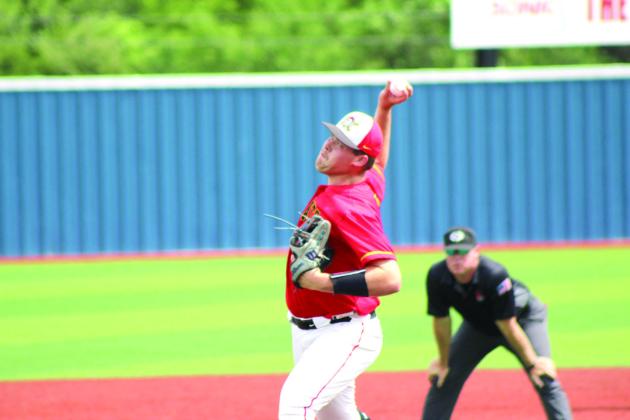 Dale junior A.J. Carpenter winds up and hurls the pitch over home plate.
