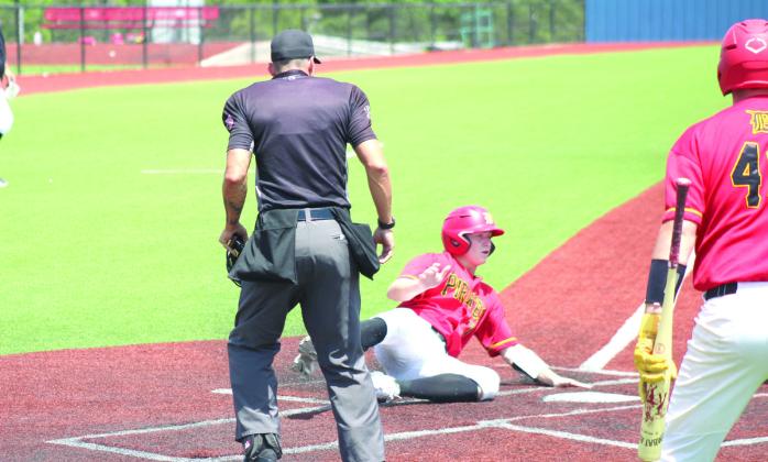 Dale junior Denton Forsythe slides across home plate.