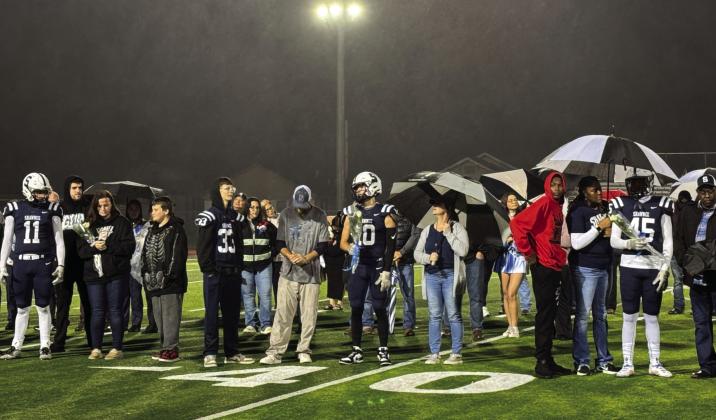 Football players and their families participate in the Shawnee High School Fall Senior Night - a very rainy night - on Nov. 8. Band, cheer, choir and cross country seniors were also included. Photo provided by Amanda Johnson