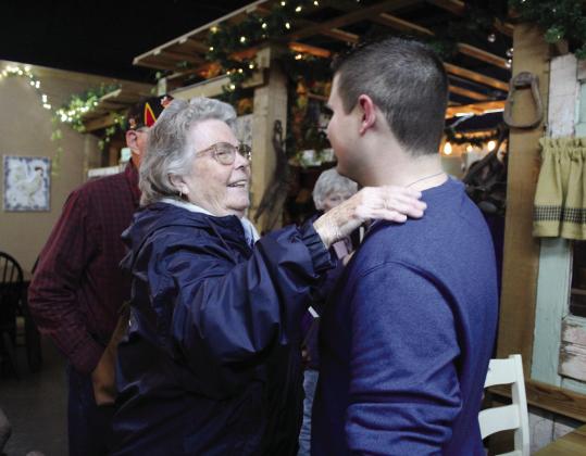 Tecumseh author Joey Perry, right, is congratulated by his great aunt Rebecca Anson, of Seminole, during the launch of his memoir at The Farmer’s Daughter Market on Dec. 2. Perry sold out of all 60 copies of his book, “I Have a Reason: An Autistic Perspective on Bullying.” Countywide &amp;amp; Sun/Natasha Dunagan
