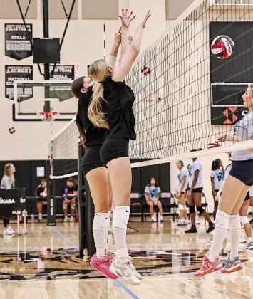 Tecumseh players Kenzie Benge and Destiny Grove block a Shawnee ball.