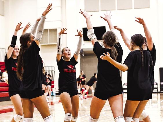 NRC celebrates a win over Shawnee in the first game of the three-way volleyball scrimmage with Tecumseh and Shawnee on Aug. 3.