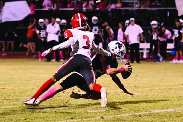 North Rock Creek’s Tyson Hawkins stops the Perkins quarterback in action Friday, Oct. 20.