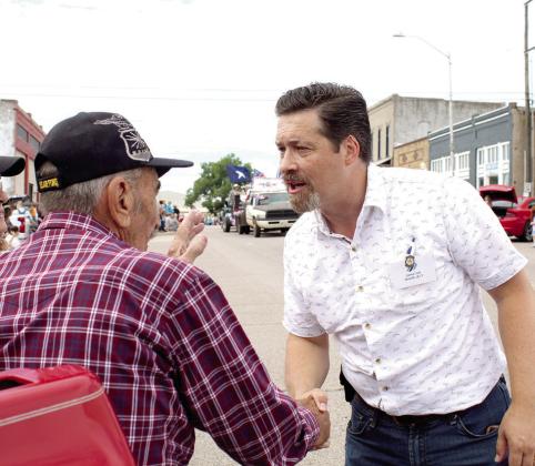 Oklahoma Senator Shane Jett shakes hands with retired U.S. Air Force veteran Don Murphey of McLoud during the McLoud Blackberry Festival parade on July 8. Murphey was in the Air Force for 27 years.