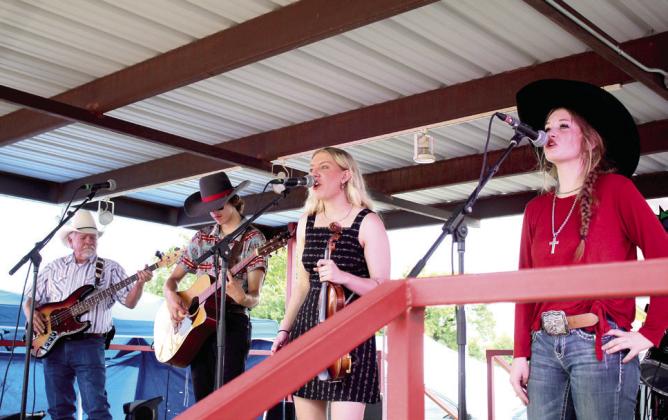 The McKedys perform “Navajo Trail” at the McLoud Blackberry Festival on July 8. Shown, from left, are bassist Terry Dobbs, Austin McKedy, Mackynsie McKedy and guest singer Sienna Rose. Not shown are drummer Rick McKee and steel guitarist Byron McKedy. Ross Clayton, Erin Michelle, Jake McGehee and The Wise Guys also performed at the two-day festival. Countywide &amp;amp; Sun/Natasha Dunagan