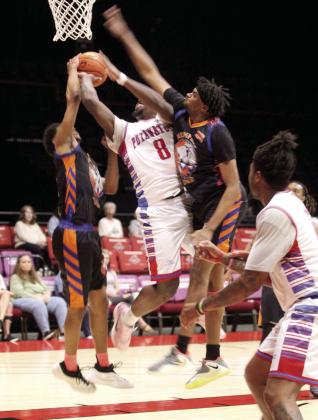 Potawatomi Fire forward K.D. Moore is blocked by two Memphis Lions defenders as he tries for a basket.