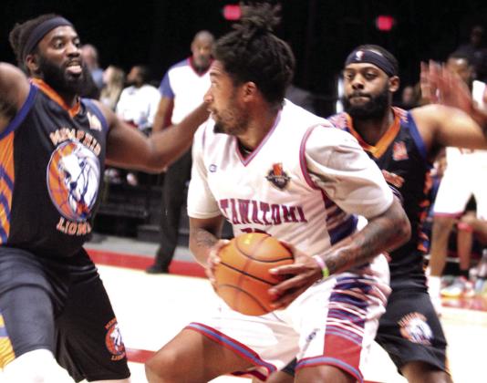 Potawatomi Fire forward/center T.J. Maston grabs the rebound before passing during the exhibition game against Memphis on Feb. 28.