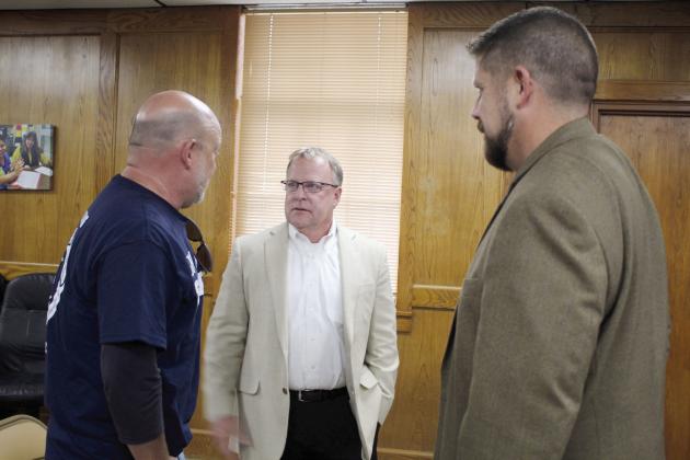 Ron Stearns speaks with Athletic Director Dax Leone, far left, and Superintendent Dr. Aaron Espolt, far right, at the Shawnee Board of Education meeting on Aug. 7. Stearns was hired as the new Executive Director of Operations during the meeting. He has 32 years of experience in education at Mid-Del Schools. Countywide &amp;amp; Sun/Natasha Dunagan