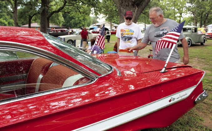 After a shower that morning, David Carter of McLoud takes a squeegee to his 1961 Chevy Impala, as Bobby Butler of Dale looks on, during the 38th Annual Knights Auto Club Car Show on June 28 at Boy Scout Park in Shawnee. Butler's entry was a 1964 Ford Falcon. There were 203 entries and 11 club cars, said Lisa Schultz with the club in an email. Natasha Dunagan, Countywide &amp;amp; Sun