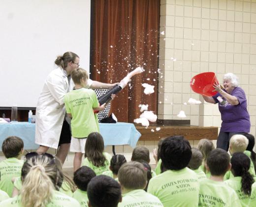 Dr. Arthropod uses a leaf blower and a sock full of suds to create pink clouds, as Tecumseh Librarian Jerilyn Hart tries to catch them in a laundry basket, and Morris gets assistance from two CPN After-School Program students (one hidden).