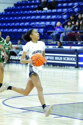 After stealing the ball, Shawnee sophomore Tarilyn Thierry has no opposition at the bucket and sinks her shot during their first game of the Lowe’s/Firelake Arena Shawnee Invitational on Jan. 18. The Lady Wolves beat Harding Prep, 40-21; lost to Class 6A Yukon, 33-44, on Jan. 19; and toppled Coweta, 45-33, Jan. 20, to take third place in the tournament.