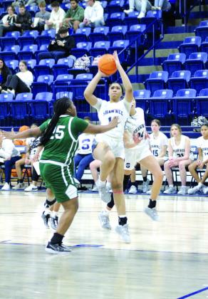 Shawnee freshman Chrishelle Milum tries for three points and gets a foul during their first game of the Lowe’s/ Firelake Arena Shawnee Invitational on Jan. 18.