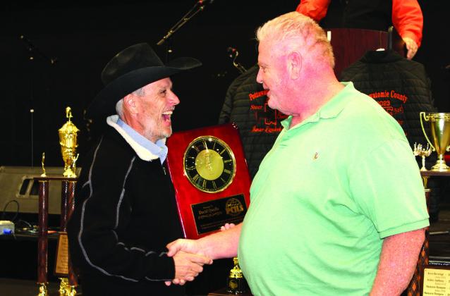 PCJLS Committee Member Matt Griffith has a laugh while presenting a clock plaque to Honoree David Qualls, the FireLake Arena general manager, during the 35th Annual Pig Roast &amp;amp; Trophy Auction on Feb. 5, 2024. Natasha Dunagan, Countywide &amp;amp; Sun
