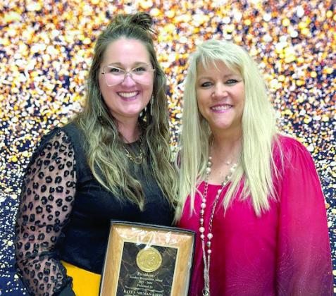Tecumseh Middle School teacher Kayla Kirby ( left) poses with Patty Stanley. Kirby received a President’s Award.