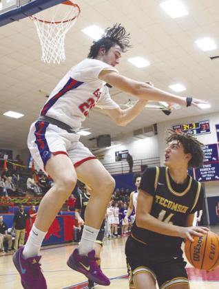 Tecumseh's Cashaw Thompson prepares to make a shot around a Chandler defender in the Jan. 31 away game. The Savages lost, 52-76. Photo courtesy of Brian Blansett