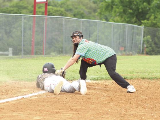 Fourth-grade teacher Lela Hopkins tags baseball player Christian Flowers out at third base.