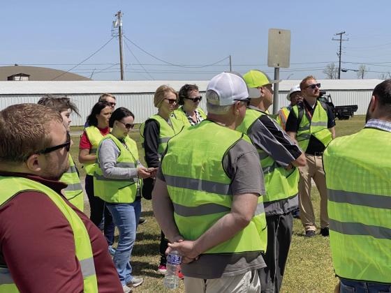 Participants of the Walking Audit in McLoud, held two days before the April tornado, stop to discuss things they have seen that could be changed or could be better. Photo provided