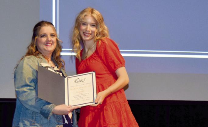 Maryl Lewellen (right), a senior at Shawnee High School, receives a Shawnee Association of Classroom Teachers Scholarship from Krista Farris, SACT president, during Monday’s Senior Awards Ceremony. Photo provided by SHS