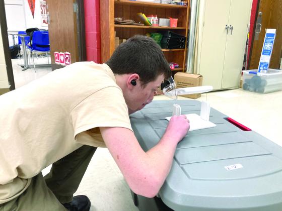 Shawnee freshman Ari Caruthers measures the " 'angle of attack,' the angle the air will hit the wing" on an airfoil, said "Launching Into Aviation" teacher Joshua Watson. As a member of the Civil Air Patrol, Caruthers was excited when the aerospace class was added at Shawnee High School this year. Photo provided by Joshua Watson.
