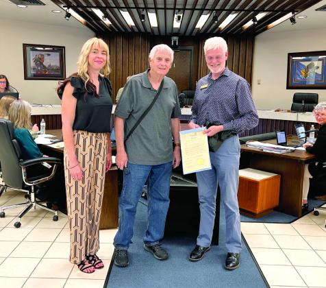 Mayor Ed Bolt Proclaimed the month of May 2024, Better Speech, Hearing, and Language Month. Doctors of Audiology Calyn Russ-White (left), and Kurt Kalies (right) receive the proclamation. Afterwards, Dr. Kalies hands out ear plugs to the those attending the meeting. Countywide &amp;amp; Sun/Suzie Campbell