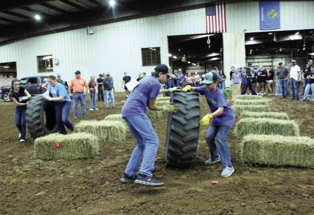 Two Bethel teams race against each other in the tire rolling portion of the Farmhand Olympics team competition. Prior to the team race, they also had individual competitions, a safety presentation, and they held a dance.
