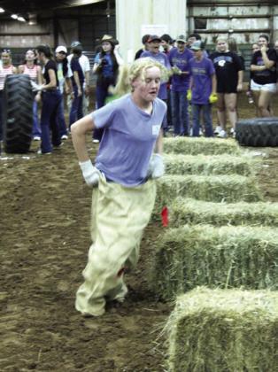 Callie Loman of Bethel takes on the sack-racing portion of the team competition during the Farmhand Olympics.