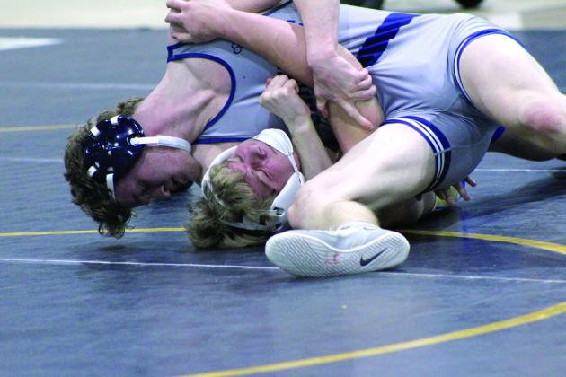 Shawnee's Jayson Hair puts the pressure on his Noble competitor during the dual meet on Jan. 25, held at the PAAC. Countywide &amp; Sun/Natasha Dunagan