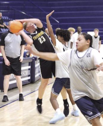 Tecumseh's Cash Phelps prepares to pass under pressure during the basketball scrimmage at Shawnee on Nov. 6. Also shown are Shawnee players Levi Baughman and Glen Price.