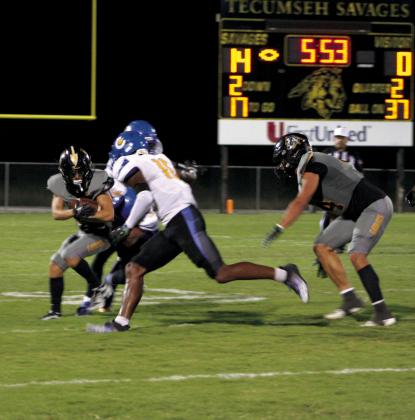 Tecumseh junior Zant Shirey dodges Classen SAS at NE players to make a first down in the second quarter of the Homecoming game on Sept. 29. The Savages won, 42-7. Countywide &amp;amp; Sun/Natasha Dunagan