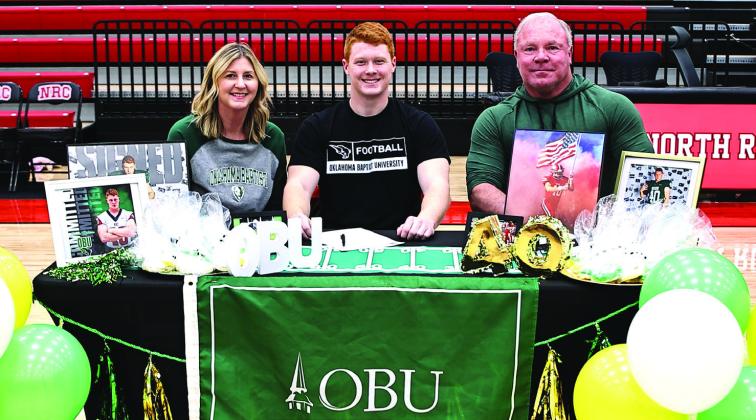 North Rock Creek's Blaine Robison signs a letter of intent to play football for Oklahoma Baptist University. Blaine is pictured with his parents Kevin &amp;amp; Allison Robison.