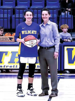 Bethel’s Parker Stevenson is presented a special basketball from Bethel Lady Wildcat Head Coach Tara Satterfield before the game Friday, Jan. 28. Stevenson, a junior, has reached the 1,000 point mark and added 24 more points to the total during the 69-12 win over Mount Saint Mary. Photo provided.