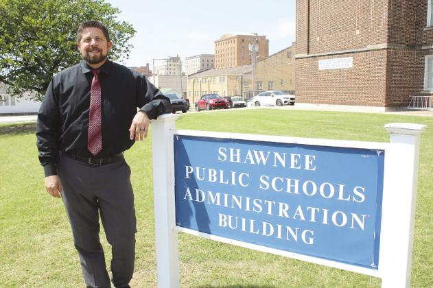 New Shawnee Superintendent Dr. Aaron Espolt stands by the Administration Building sign on July 27. Espolt said Shawnee Public Schools continue to recover from the April 19 tornadoes. They also plan to have more transparency and communication with the public this year. Countywide &amp;amp; Sun/Natasha Dunagan