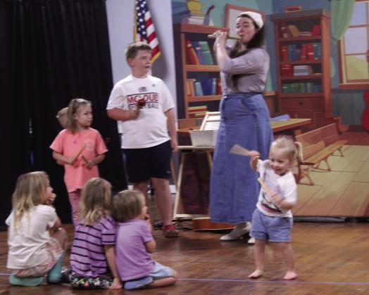 As "Pam," played by Sarah Spurlin, makes a tune on the "magic flute," a few volunteers play percussion, and one decides to dance during "The Magic Flute Goes West!" presented by Painted Sky Opera, organized by McLoud Public Library and hosted by the McLoud American Legion on July 17.