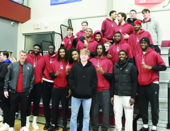 Dayton Forsythe (front, center, black jacket) is joined by OU Men’s Basketball Head Coach Porter Moser and members of the OU team, Saturday, Feb. 22. During halftime of the Dale districts game, Forsythe was honored with the retirement of his number. See the story and additional photos on page B1. Countywide &amp; Sun/Suzie Campbell