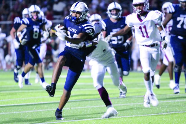 After stealing the ball, Shawnee senior Dace Shaw fights to keep from being tackled at the first home game on Sept. 13. Coming back from a loss at Putnam City North (6A) last week, Shawnee (5A) beat Ardmore (4A), 34-13.