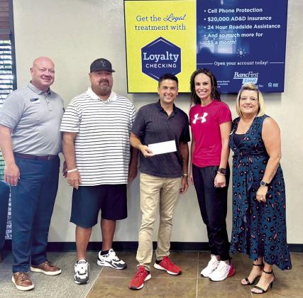 BancFirst presents Tecumseh Athletics with a $1,000 check to assist in the purchase of the 5A Slow Pitch State Championship rings. Pictured from left: BancFirst President &amp;amp; Regional Executive Casey Bell, Coach Perry Wilson, Justin Wood, Director of Community Engagement, Casi Bays, Athletic Director, and Kellie Clay Vice President, BancFirst. Photo provided