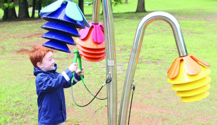 Frankie Lewis, 3, of Macomb plays the Rainbow Chimes on the Pioneer Library System Music Trail. Tecumseh Public Library had a ribbon cutting on April 25 for six new instruments, located along the northern trail of Slick Humphrey Park. Lewis's mother, Abigail Lewis, said her and her four children come to the park all the time. Natasha Dunagan, Countywide &amp; Sun