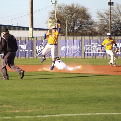 Shawnee's Zane Wilson steals second base as a Will Rogers players jumps for the ball in the first inning of the home game on March 28. The Wolves won, 10-0. Countywide &amp; Sun/Natasha Dunagan