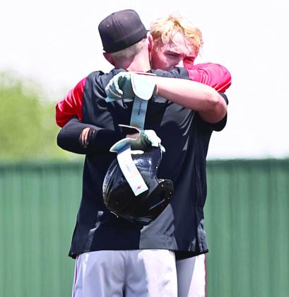 North Rock Creek's Coach Davis consoles senior Braden Ueltzen after the 2-8 loss to Blanchard.
