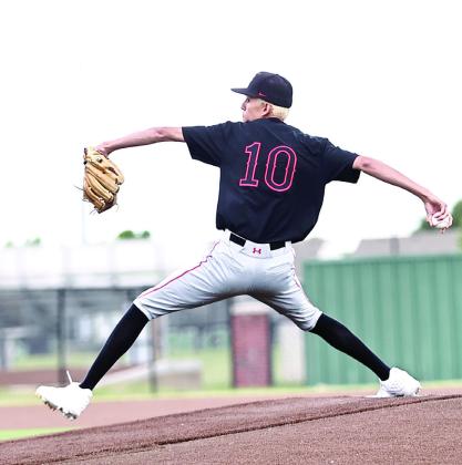 North Rock Creek's Cason Coomer, starting pitcher, winds up for the pitch.